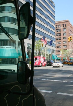 As Taim truck looks on, competition in the form of the Rickshaw dumpling truck pulls into the neighborhood. Common practice among food truck employees is to exchange food.